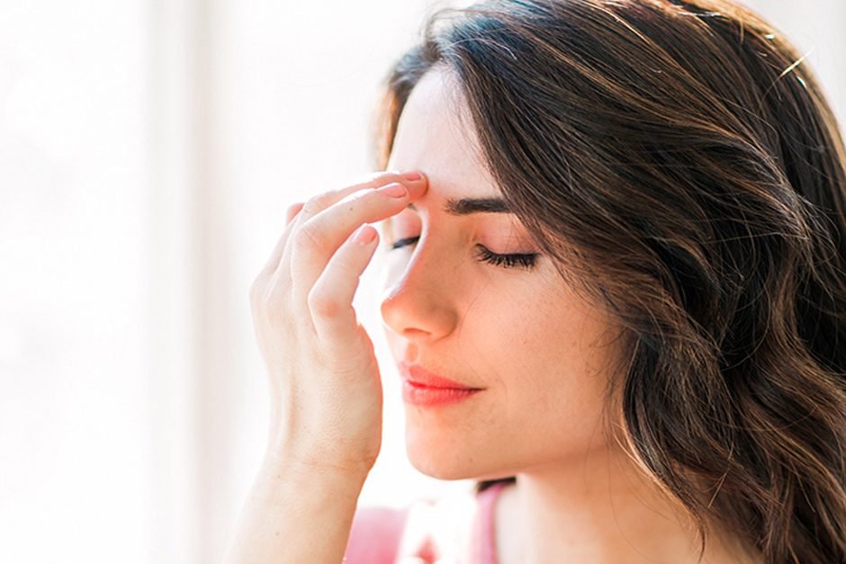 A woman tapping gently beside her eye